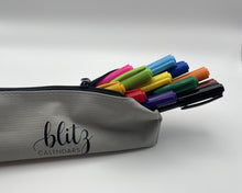 Load image into Gallery viewer, Gray pencil case with colorful markers and &#39;blitz calendars&#39; branding on a white background
