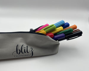 Gray pencil case with colorful markers and 'blitz calendars' branding on a white background