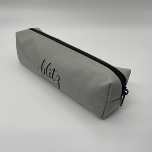 Gray pencil case with black zipper on a white background